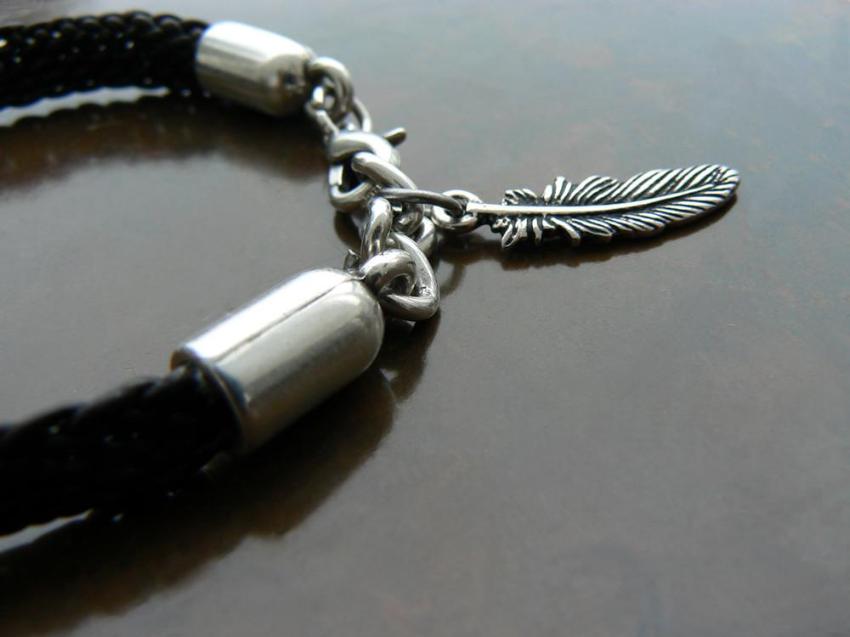 Yuki Braided Round Leather Cord Beaded Bracelet close up of silver lobster clasp and silver feather charm