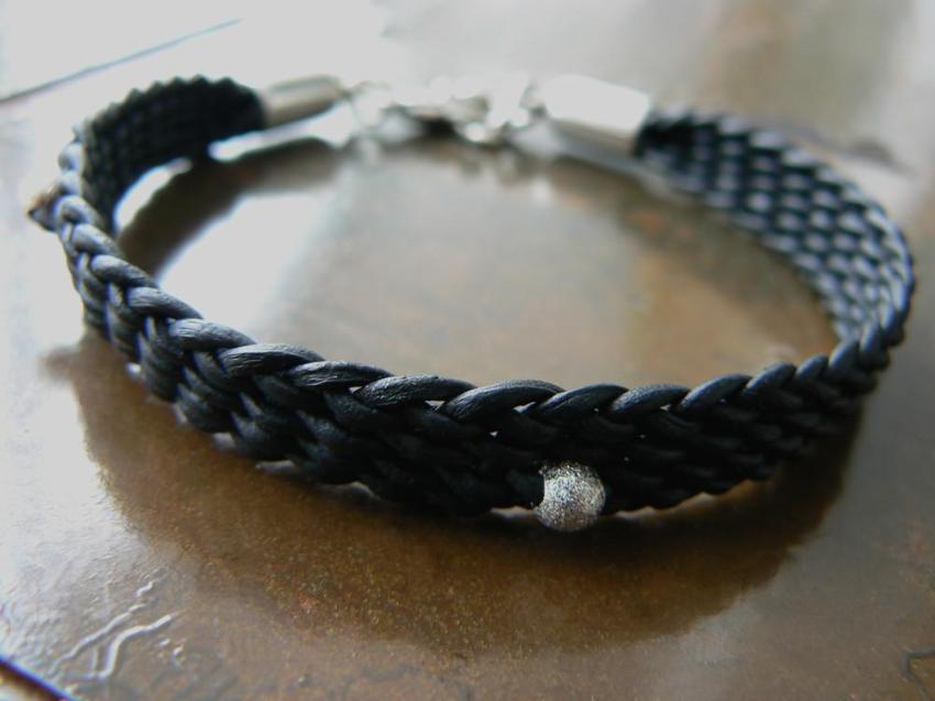 BLACK YUKI BRAIDED LEATHER BRACELET with silver lobster clasp and silver feather charm