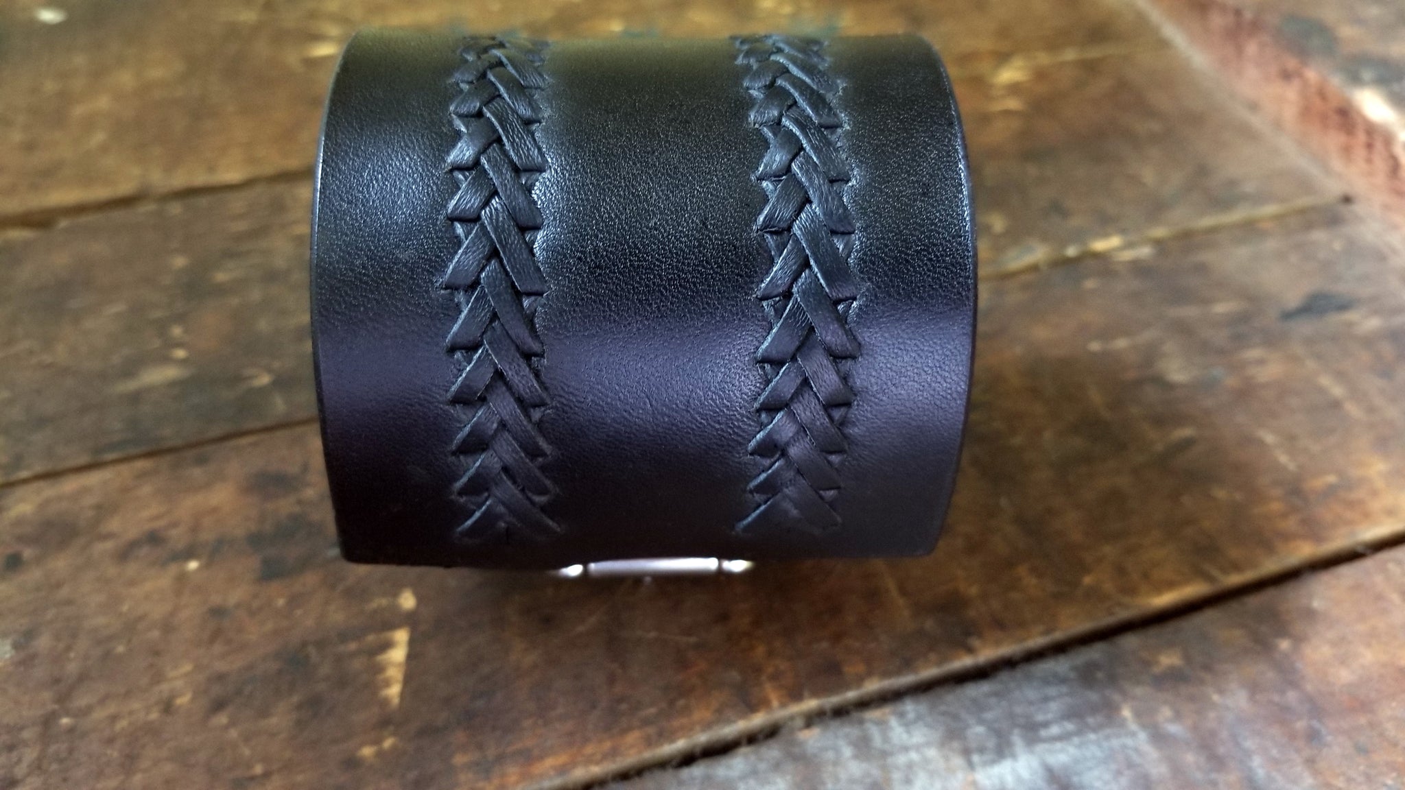 front view of the hand lacing on Aga Braided Leather Buckle Cuff, black