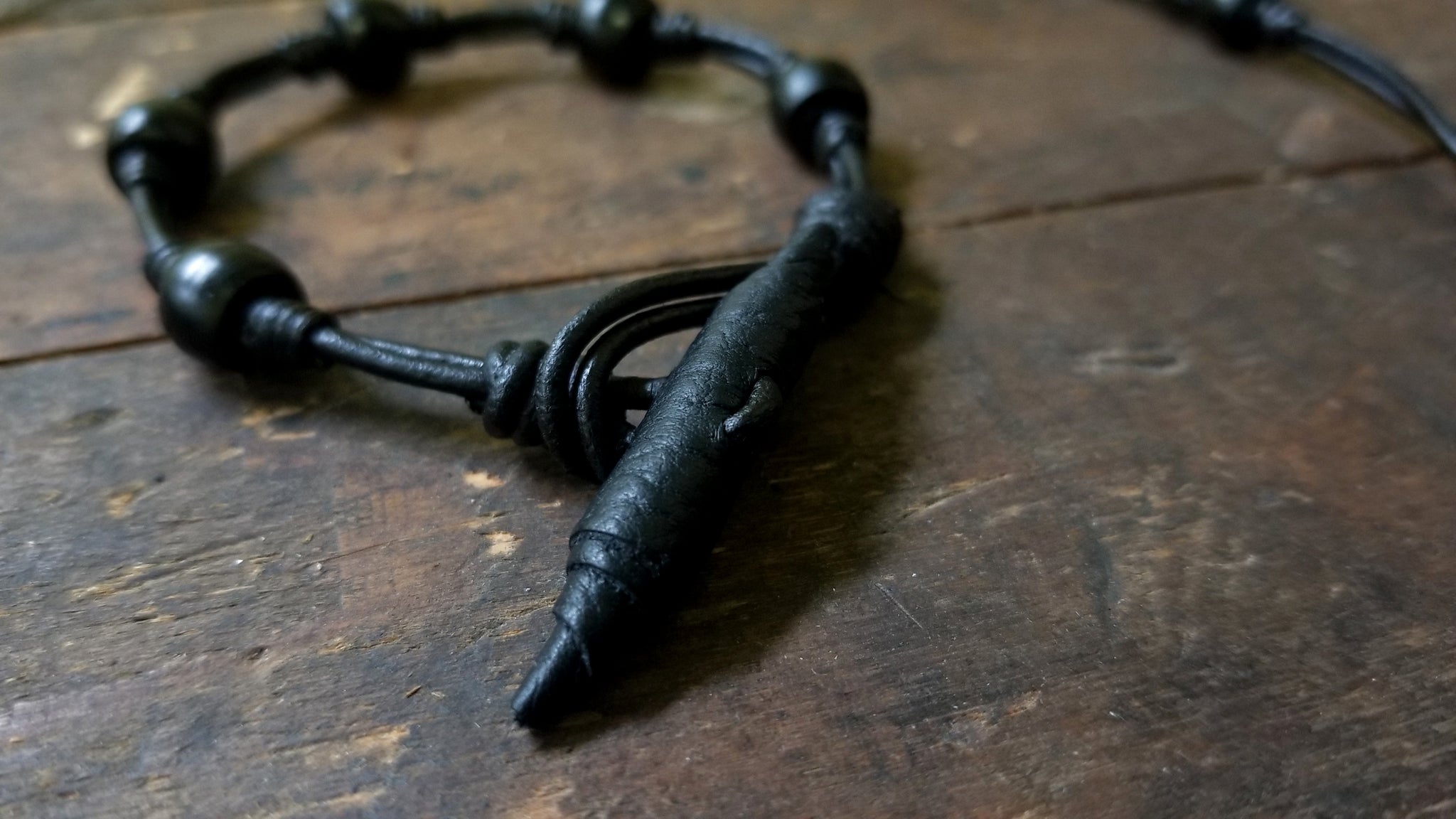 Chuma Bracelet; black leather cord with black onyx African Trade Beads, Bison Leather Button and Loop Clasp