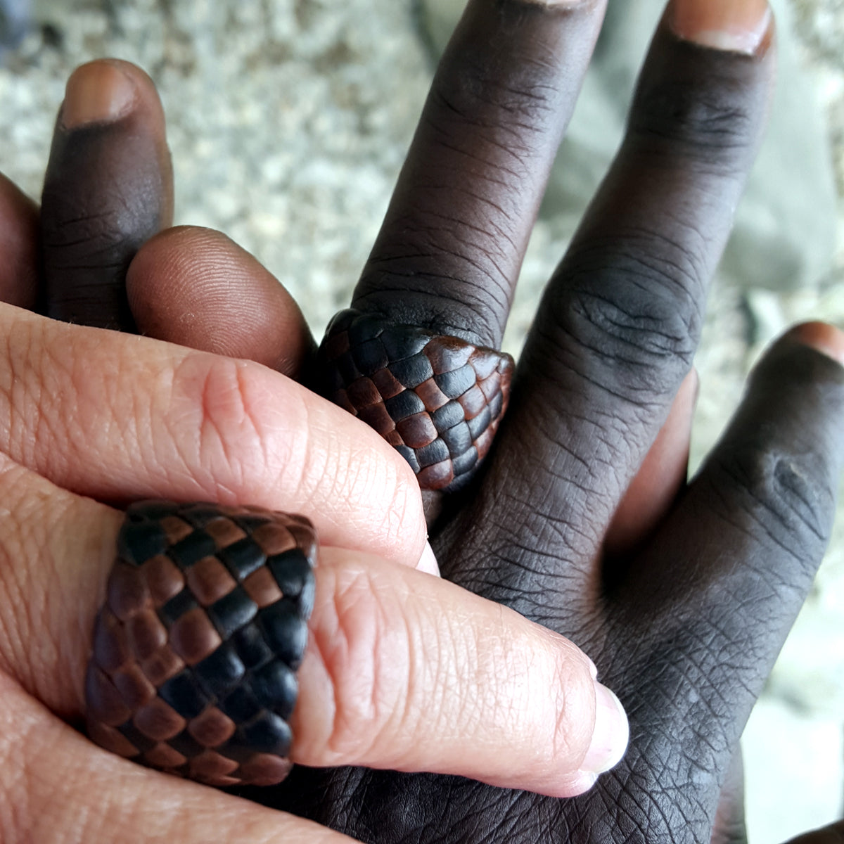 chocolate and mahogany kama braided leather rings, 3/4" and 5/8" (custom size) on male and female models