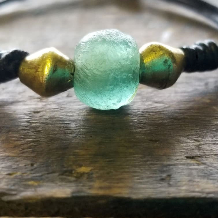 African Glass Bead in aquamarine and African brass Dome beads