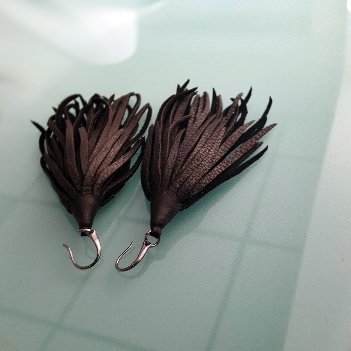 Mini-Mini Kimani Tassel Earrings in black deerskin leather with gunmetal earring hooks