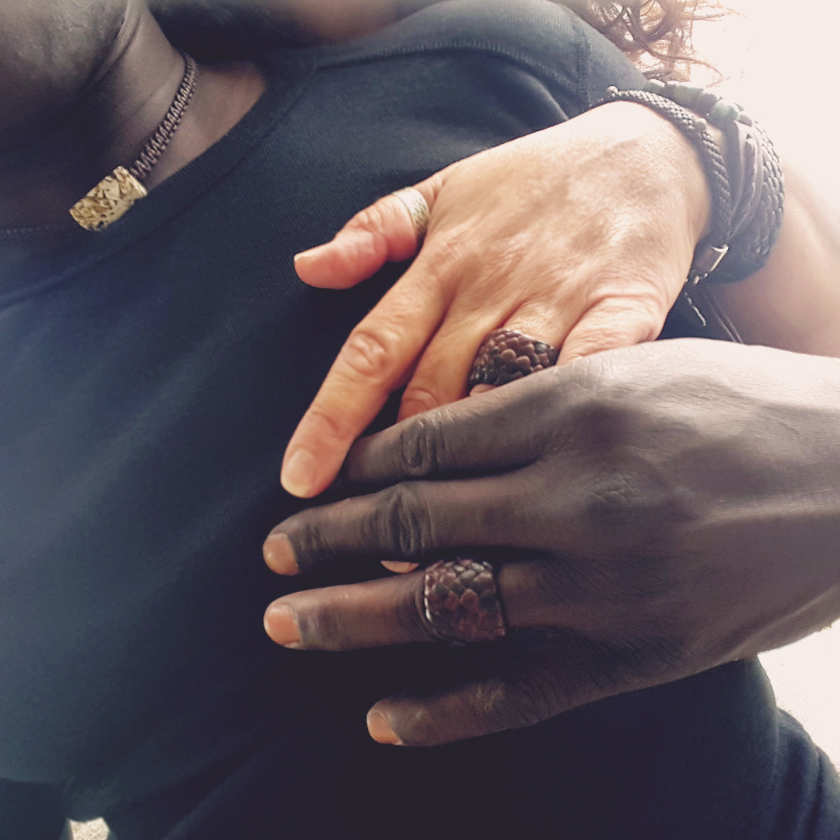 male and female model wearing mahogany and chocolate braided leather kama rings