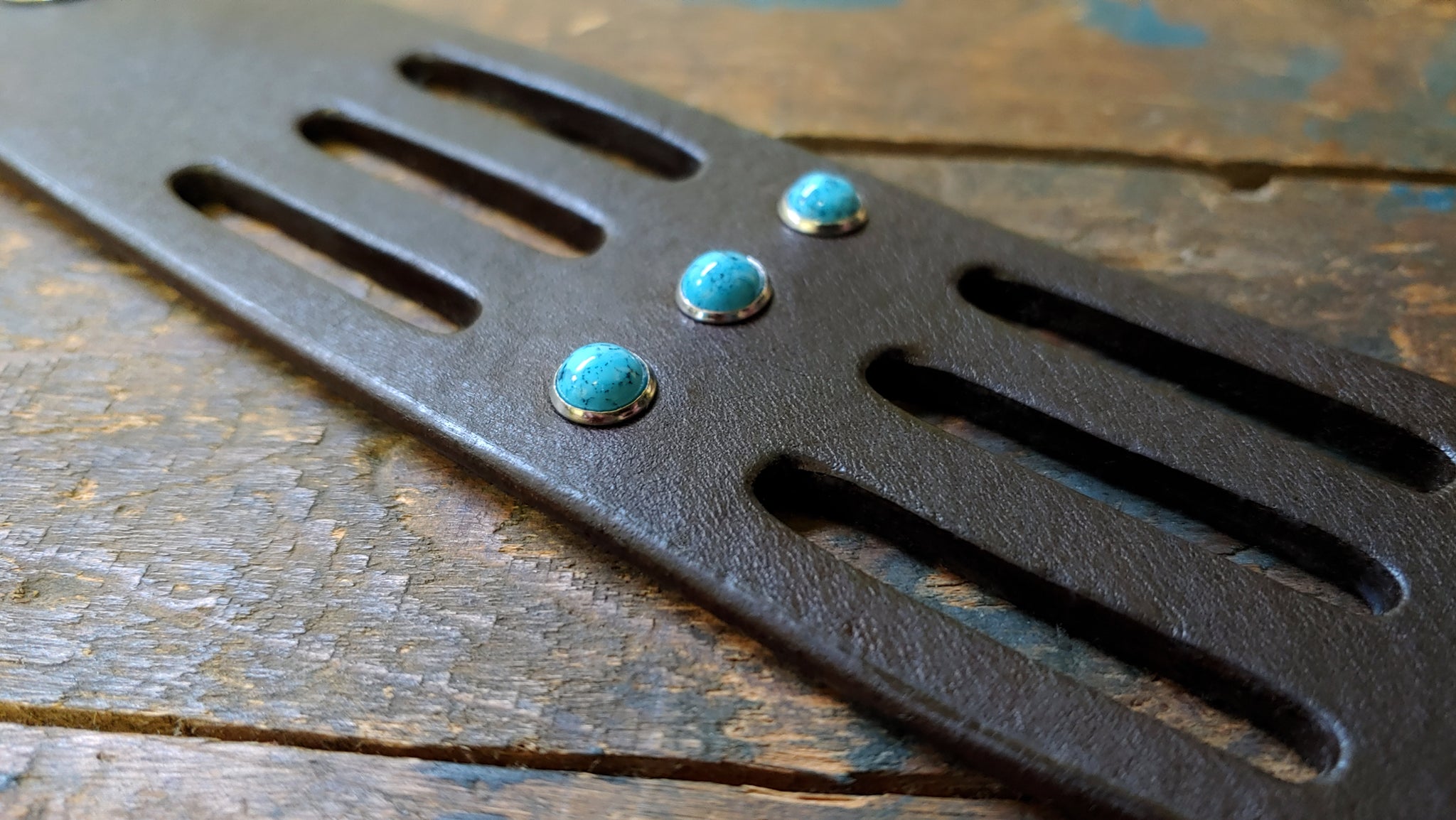 close up of Trinity Leather cuff, Chocolate Brown atec leather with turquoise rivets