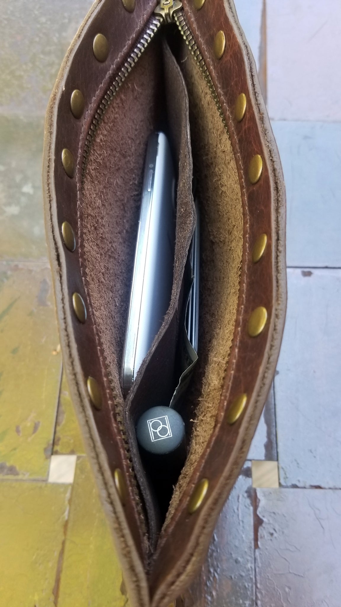 interior of leather wristlet with braided leather handle, part of the Malia Collection of tote bags and purses. In Navajo Canela Bison