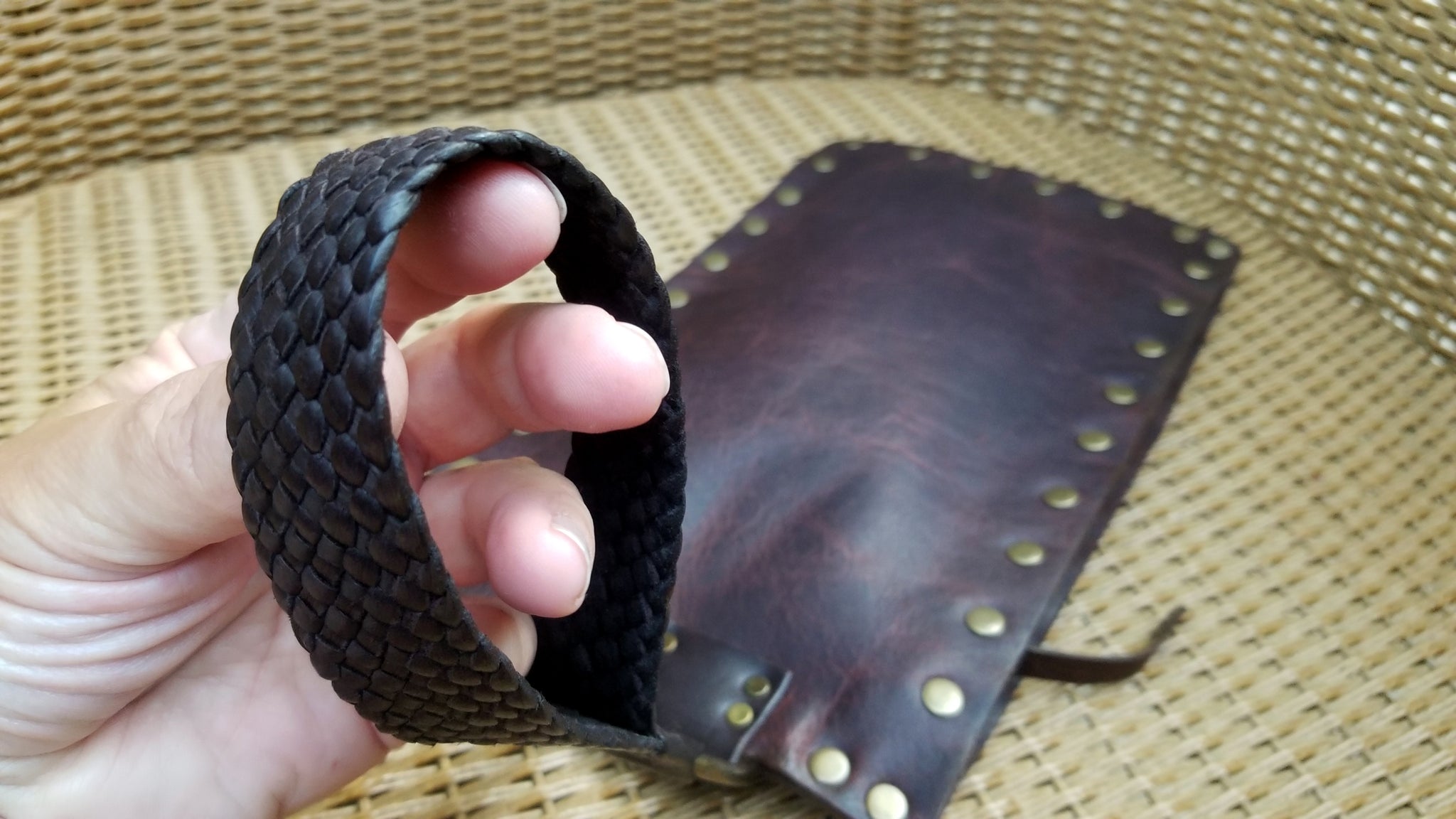 braided leather handle bracelet strap close up in hand- carnela brown bison - wirstlet purse