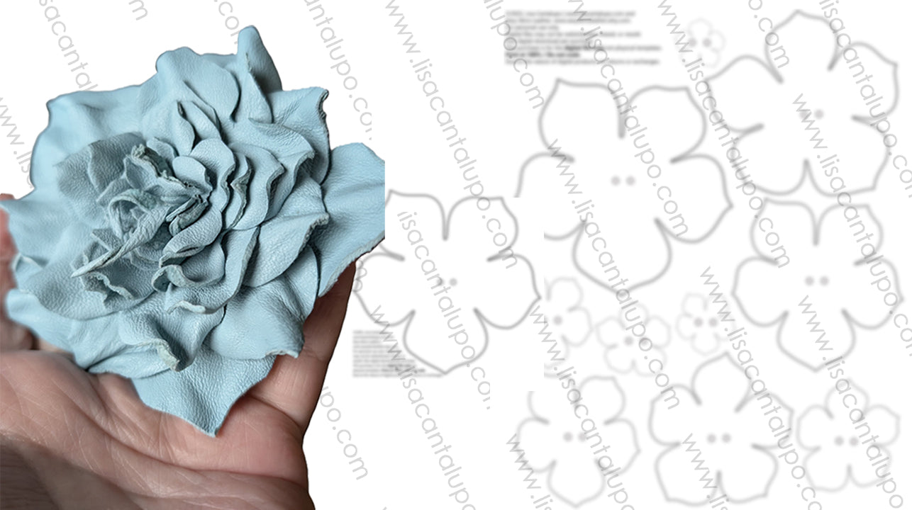 Light blue leather flower held by a hand with white floral stencils template downloads in the background