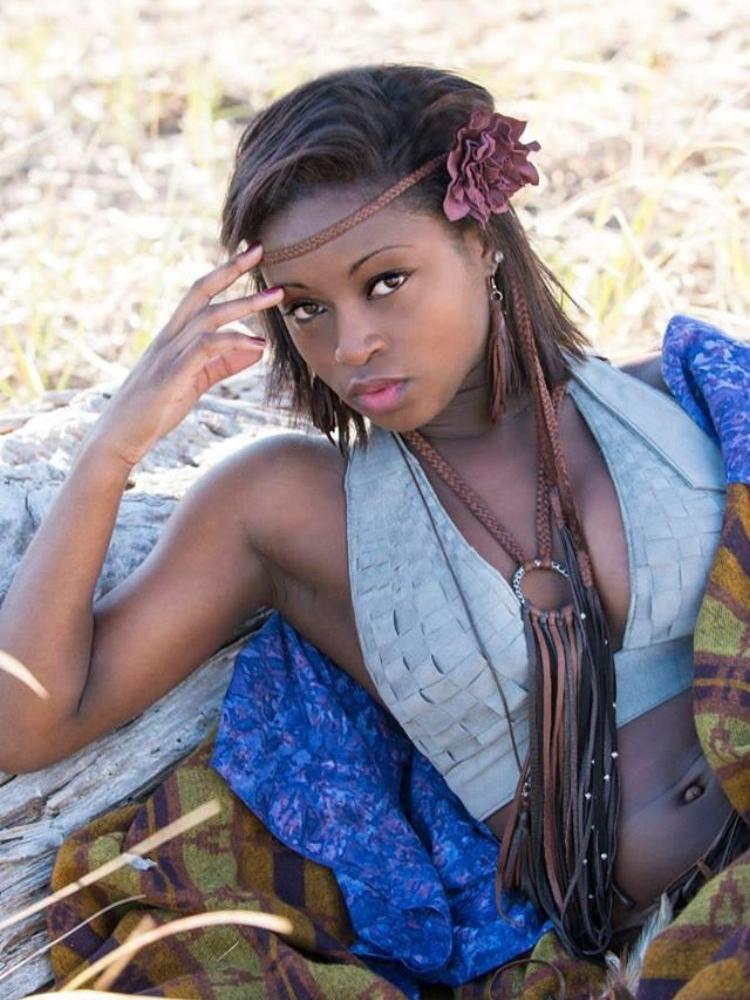 model wearing eggplant pig sued flower Mandisa Leather Flower Braided Deerskin Headband, choker necklace and belt