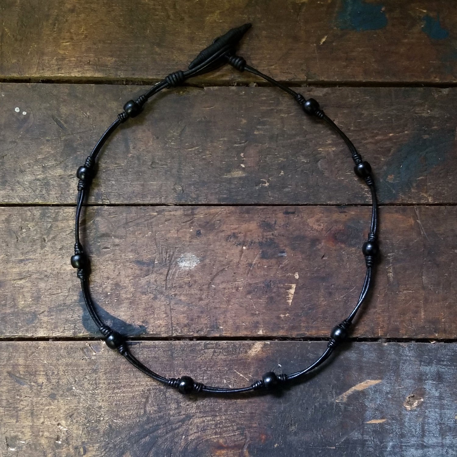 Chuma necklace; black leather cord with black onyx African Trade Beads, Bison Leather Button and Loop Clasp