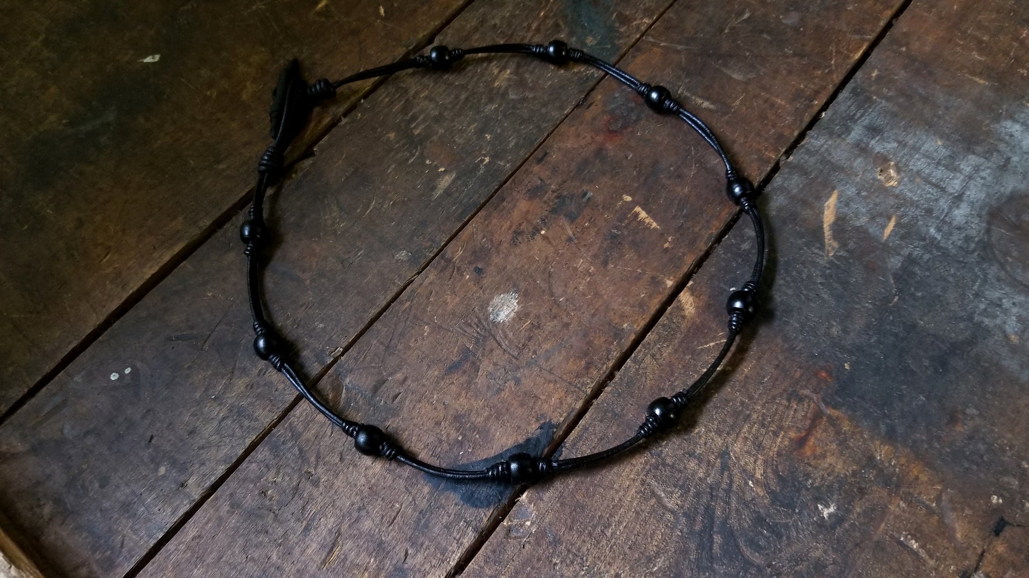 Chuma necklace; black leather cord with black onyx African Trade Beads, Bison Leather Button and Loop Clasp