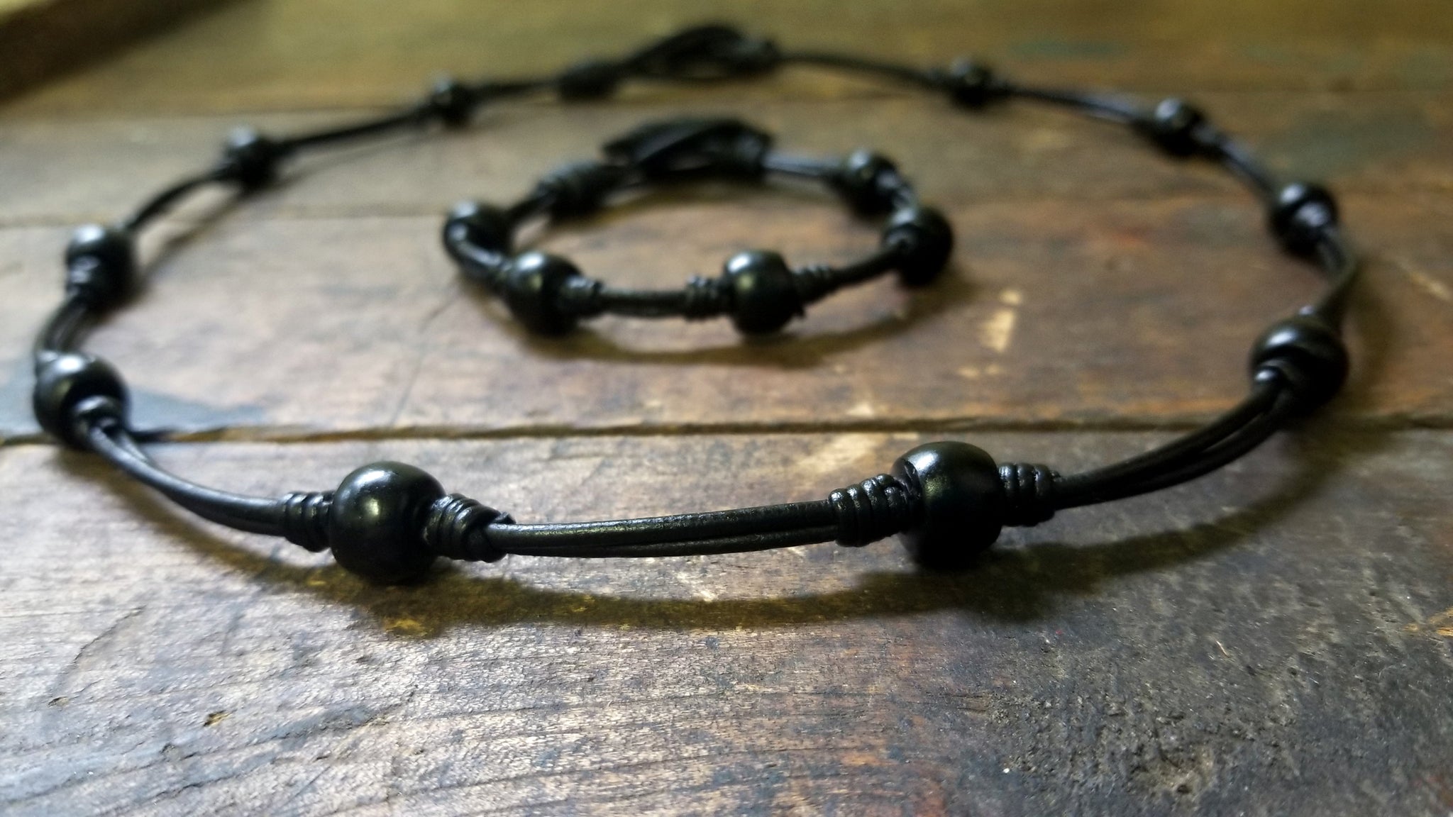 Chuma Necklace and Bracelet Set; black leather cord with black onyx African Trade Beads, Bison Leather Button and Loop Clasp