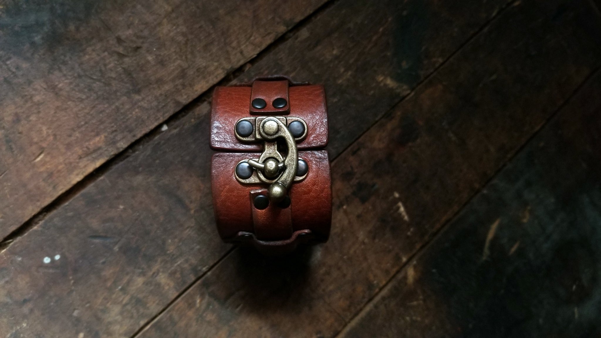 Hook Leather Cuff - Slim. Wide leather snap cuff with antique brass hook & latch in the color tobacco