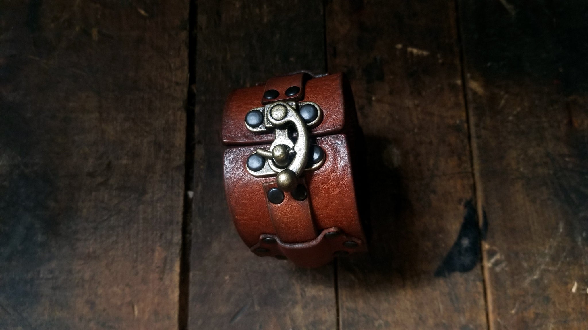 Hook Leather Cuff - Slim. Wide leather snap cuff with antique brass hook & latch in the color tobacco