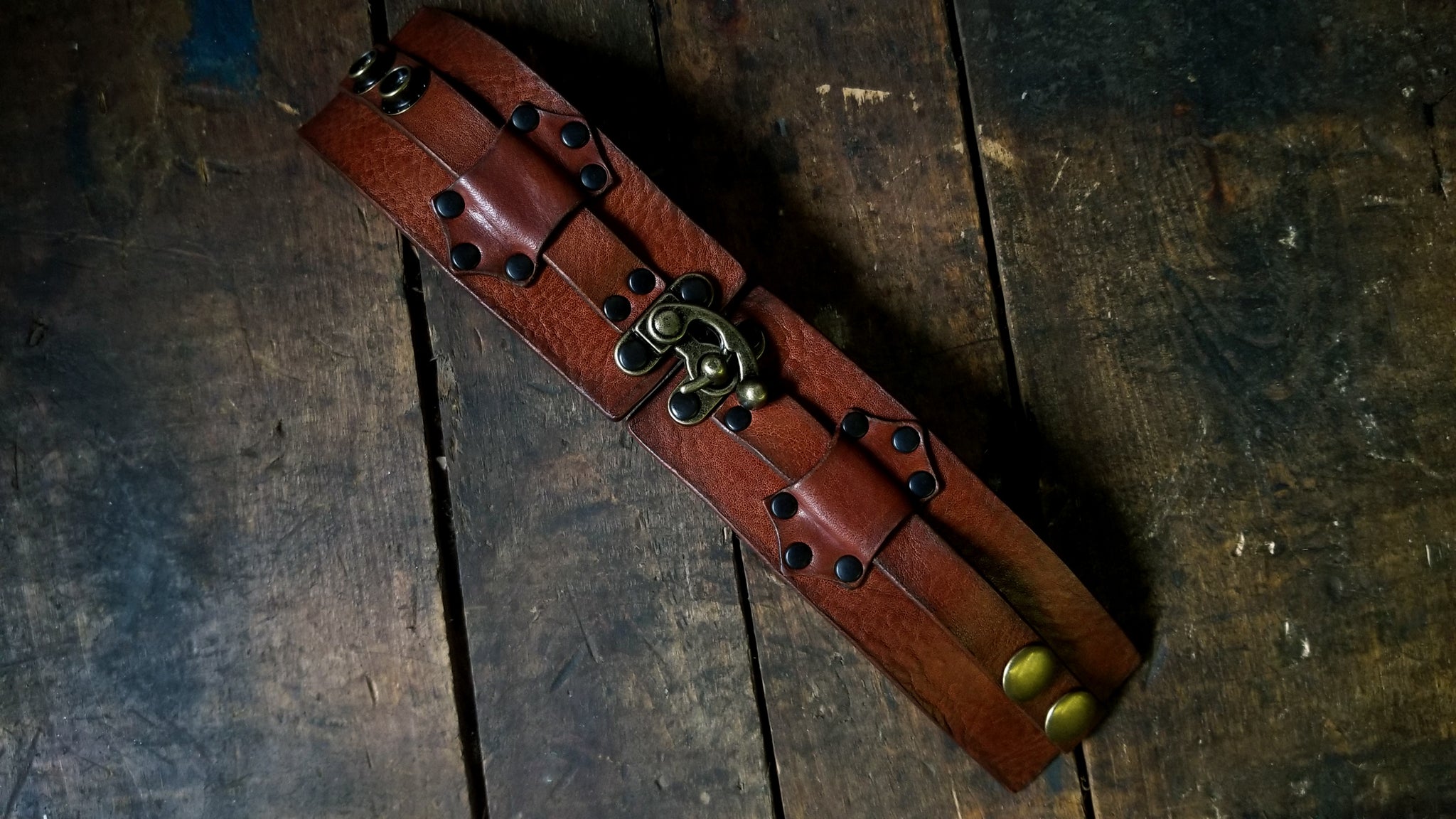 Hook Leather Cuff - Slim. Wide leather snap cuff with antique brass hook & latch in the color tobacco