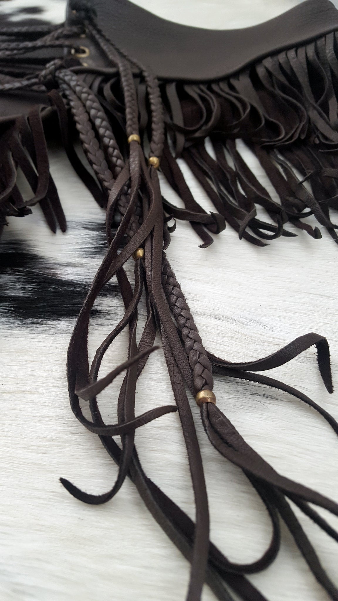 close up image of deerskin leather booty shorts, booty shorts braided laced ties and fringe