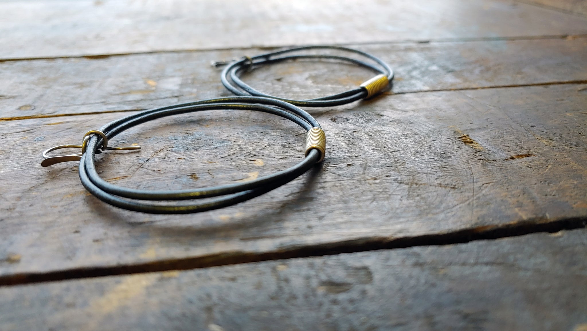 Oki leather cord earrings with handmade silver African spiral beads in gunmetal metallic round leather cord