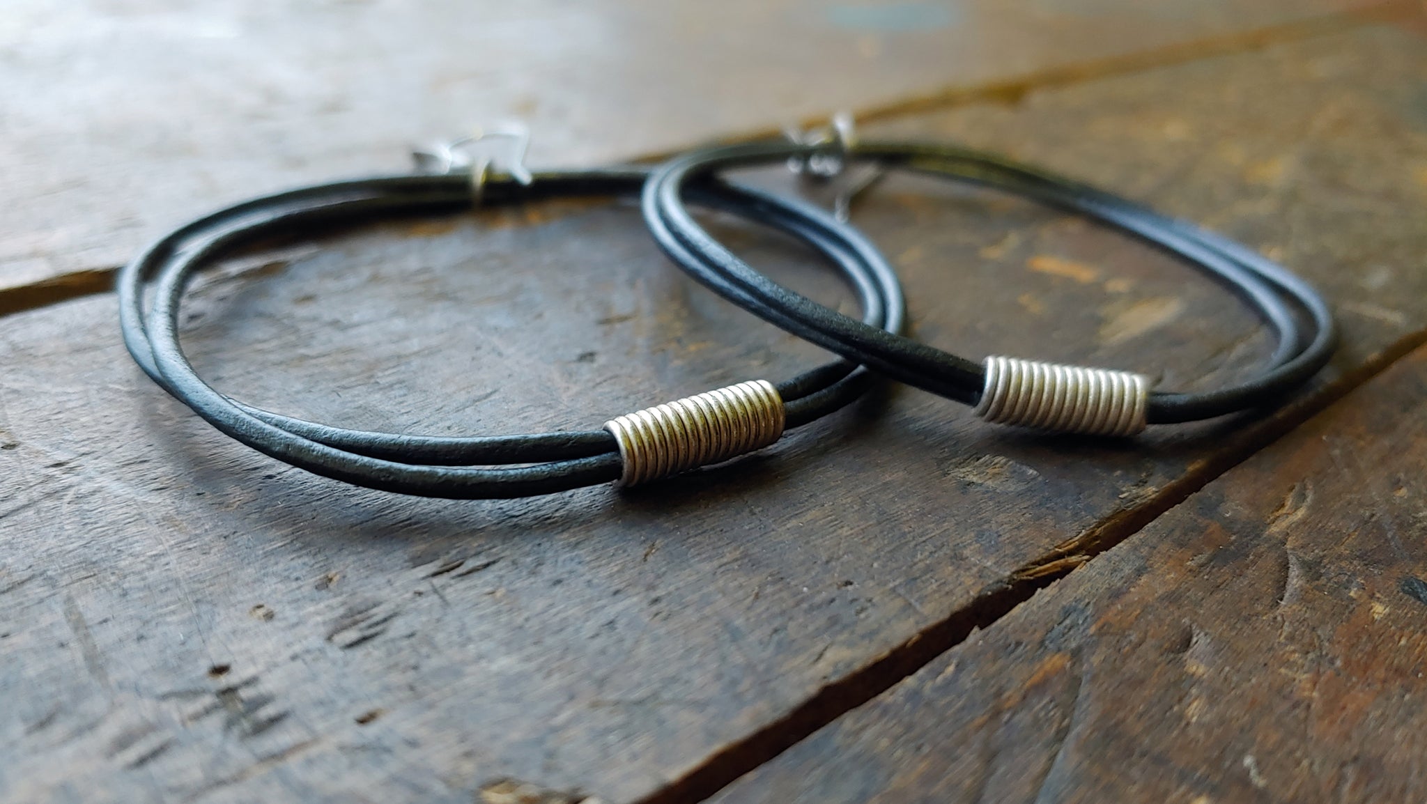 Oki leather cord earrings with handmade silver African spiral beads in gunmetal metallic round leather cord