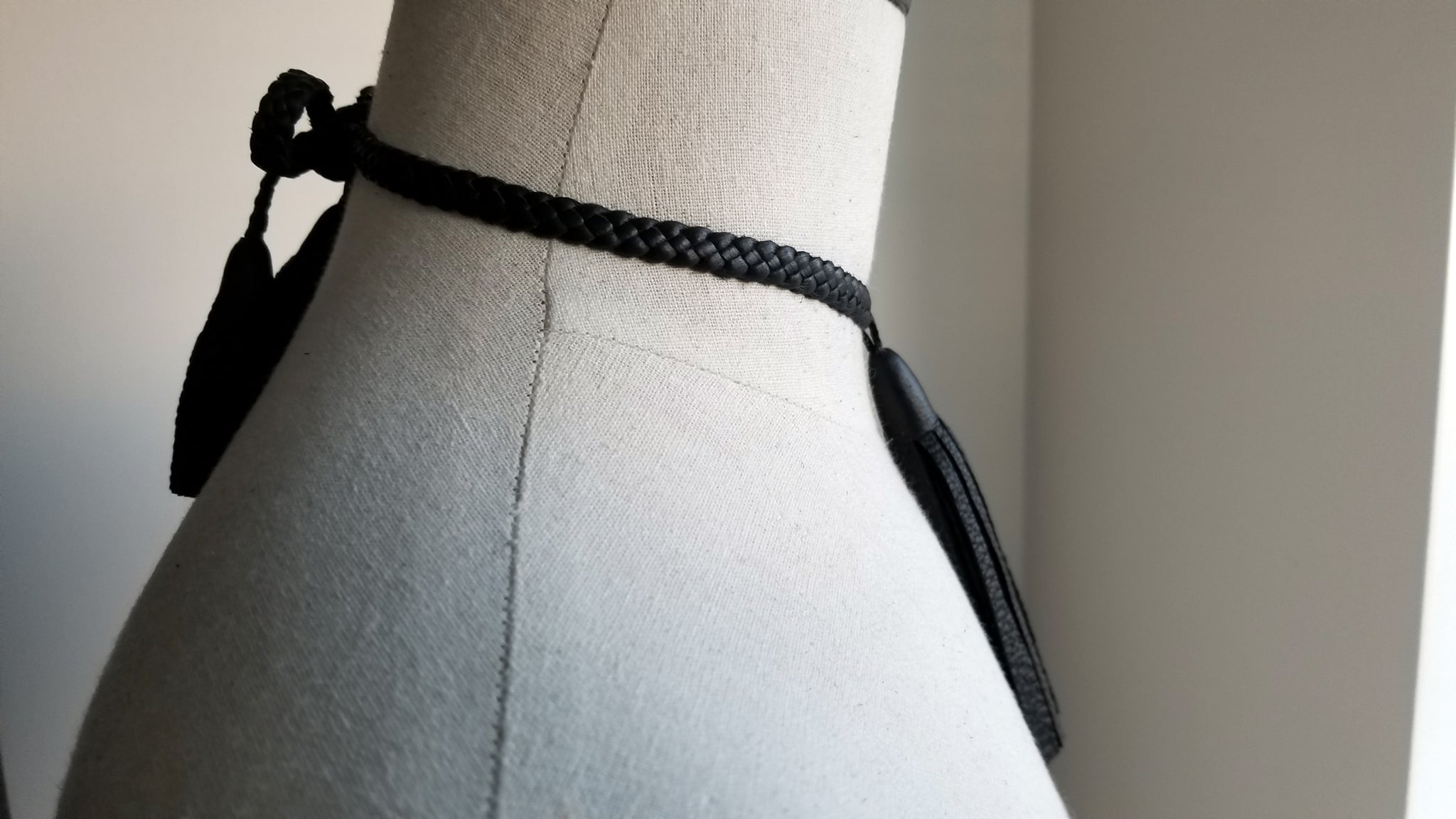 Tilu Leather Tassel Necklace side view bow and tassels, in black deerskin leather